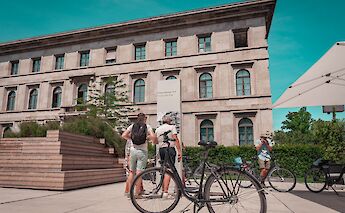 Pausing at a historic site, Munich, Germany. CC:Radius Tours