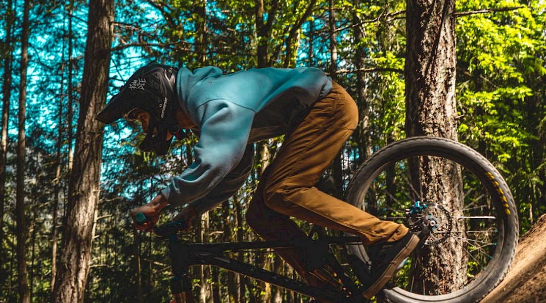 Mountain bike tour through woods. Unsplash:Jasper Garratt