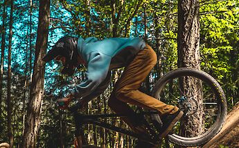 Mountain bike tour through woods. Unsplash:Jasper Garratt