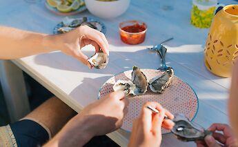 Eating oysters outside. Charlotte Harrison@Unsplash