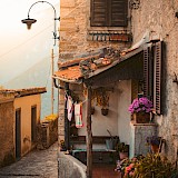Stone house located at a narrow street, Tuscany. Unsplash:Redcharlie