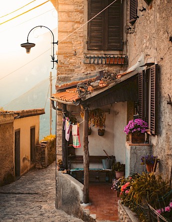 Stone house located at a narrow street, Tuscany. Unsplash:Redcharlie