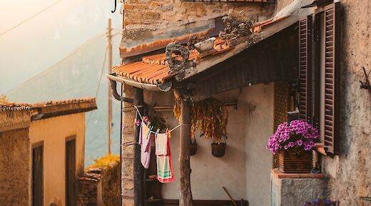 Stone house located at a narrow street, Tuscany. Unsplash:Redcharlie