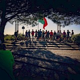 Standing with bikes beneath the flag. Lisbon Cycle Tours