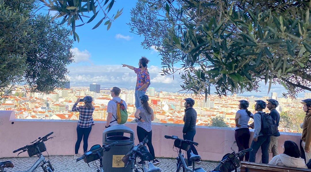 Cyclists on a 7 Hills tour, at the viewpoint, Lisbon. Lisbon Cycle Tours