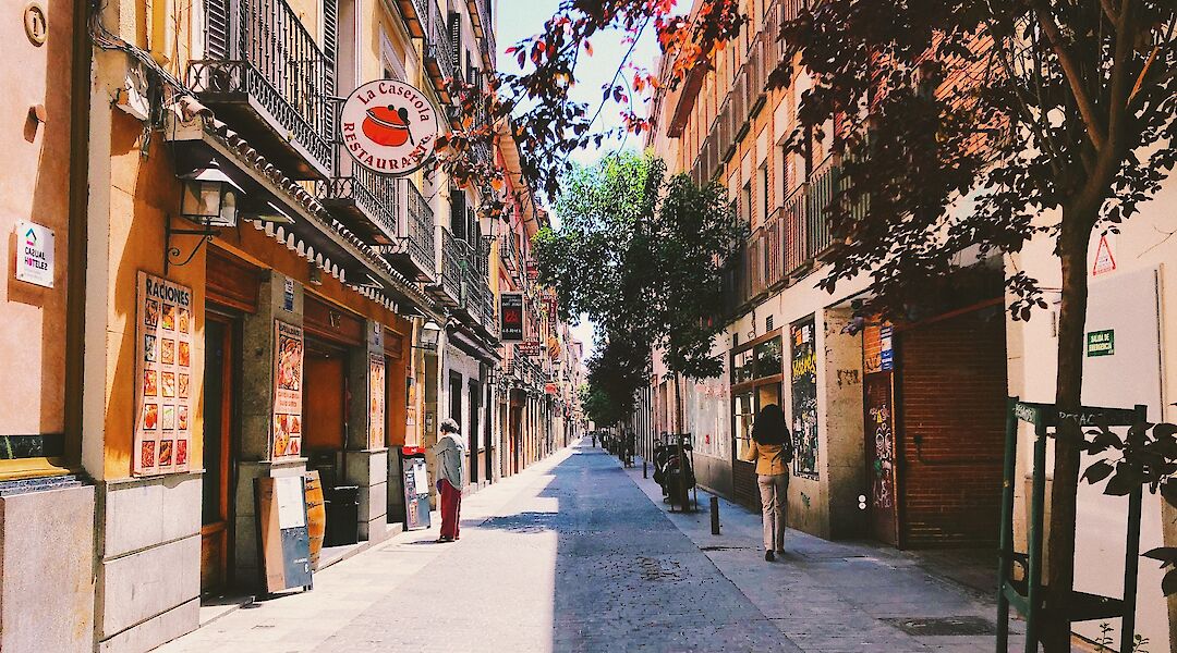 Pedestrian street with shops in downtown Madrid. Unsplash: Alex Vasey