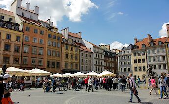 People walking through a square, Warsaw, Poland. Unsplash:Fikri Ahmad Maulana