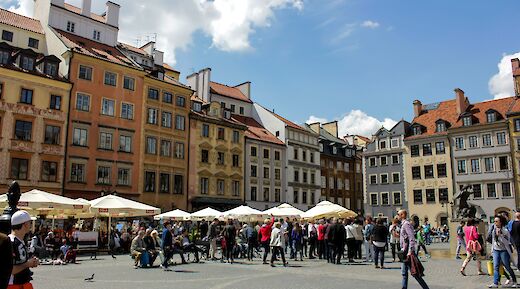 People walking through a square, Warsaw, Poland. Unsplash:Fikri Ahmad Maulana