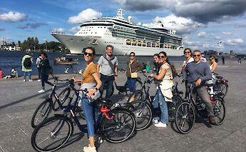 Bike tour group by the river, Amsterdam bike tour, Holland. CC:TO