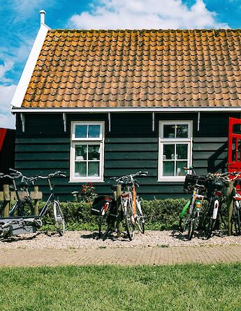 Bikes parked by the path in Monnickendam, Holland bike tour. Ashim D Silva@Unsplash