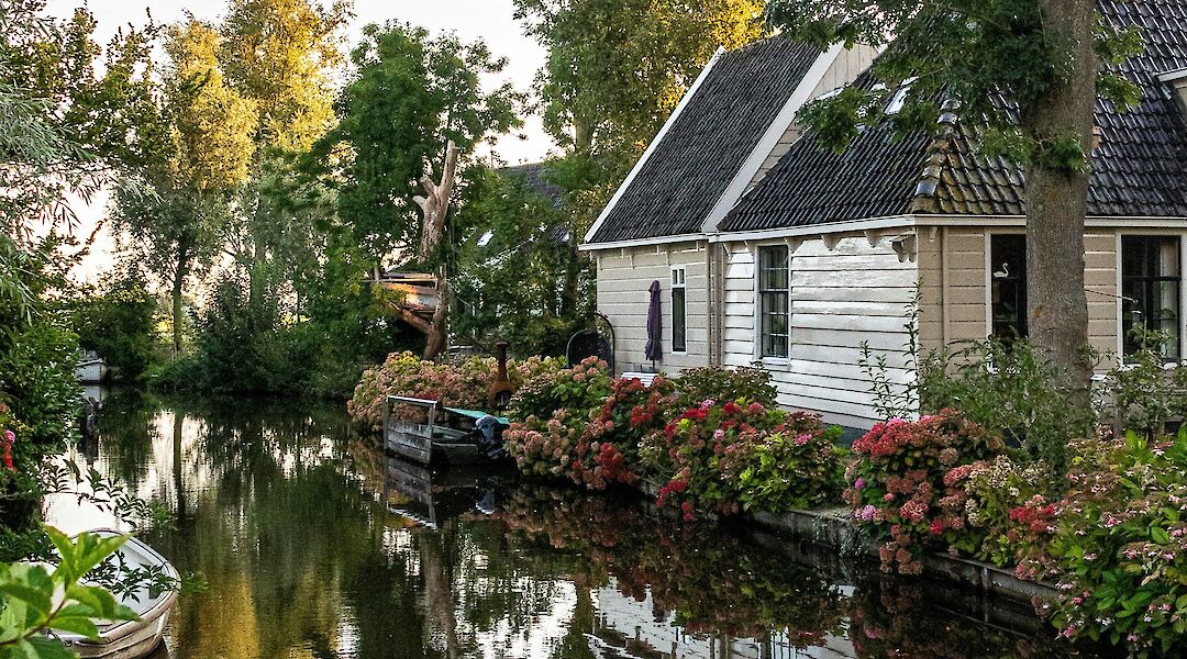 Reflections on the water in Broek in Waterland, Holland bike tour. Ruud Slinger@Unsplash