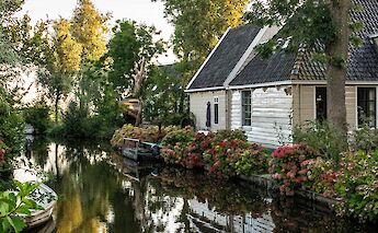 Reflections on the water in Broek in Waterland, Holland bike tour. Ruud Slinger@Unsplash