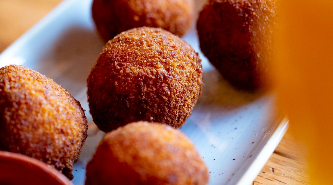 Arancini, deep fried rice balls, a staple of Sicilian cuisine. Unsplash:Clark Douglas