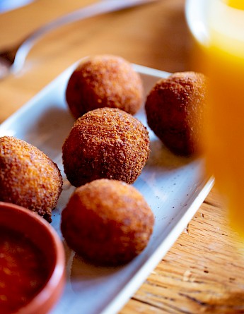 Arancini, deep fried rice balls, a staple of Sicilian cuisine. Unsplash:Clark Douglas