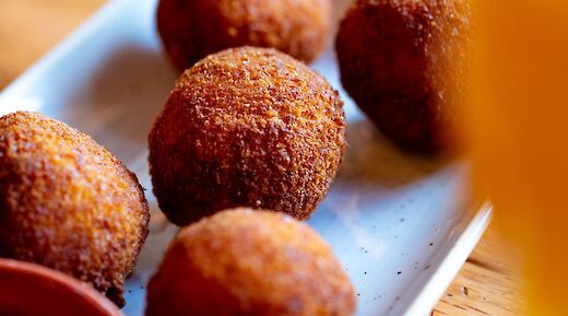 Arancini, deep fried rice balls, a staple of Sicilian cuisine. Unsplash:Clark Douglas