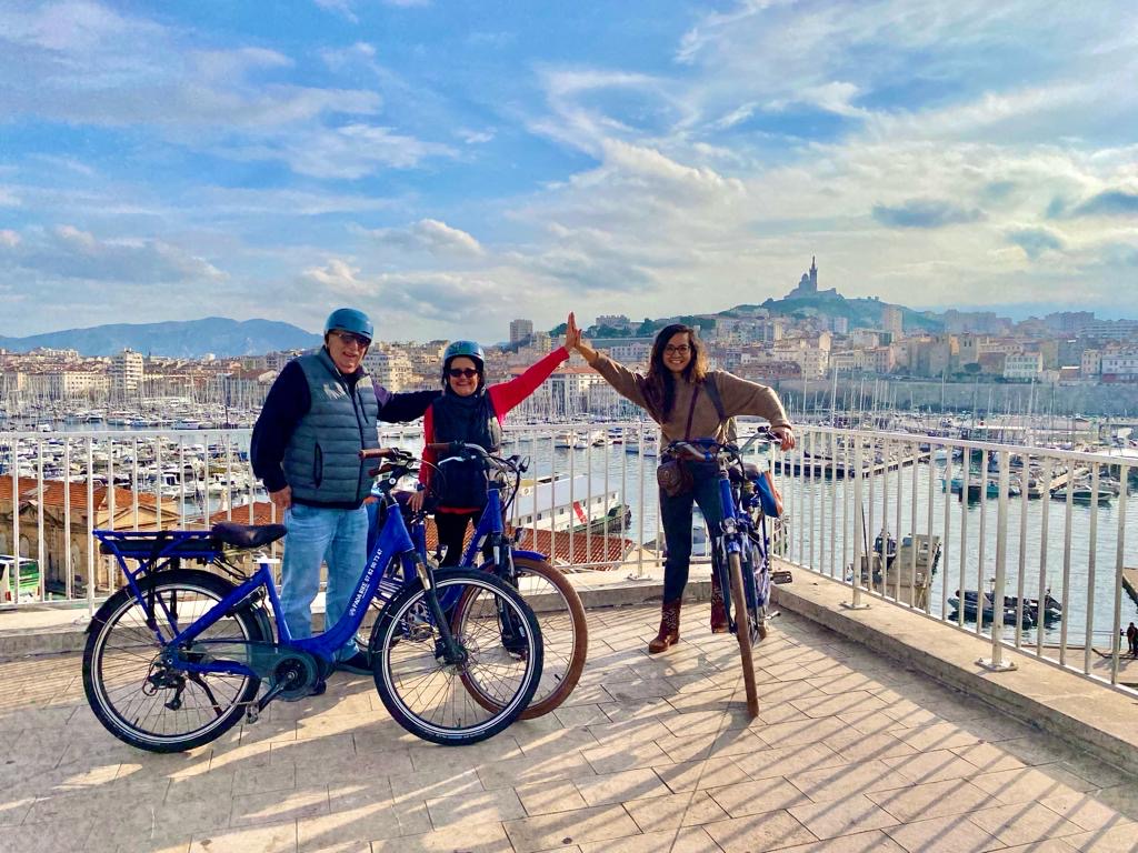 High five at a viewpoint, Marseille e-bike tour, France. CC:TO