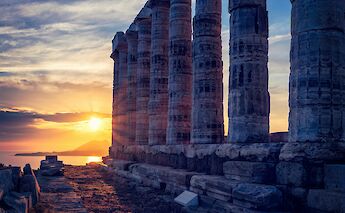 The sun setting behind the pillars, Athens, Greece. Getty Images@Unsplash