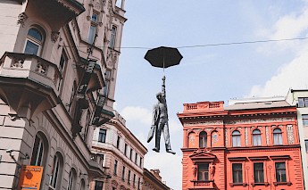 Statue - Man with an umbrella, Prague. Nastya Dulhiier@Unsplash