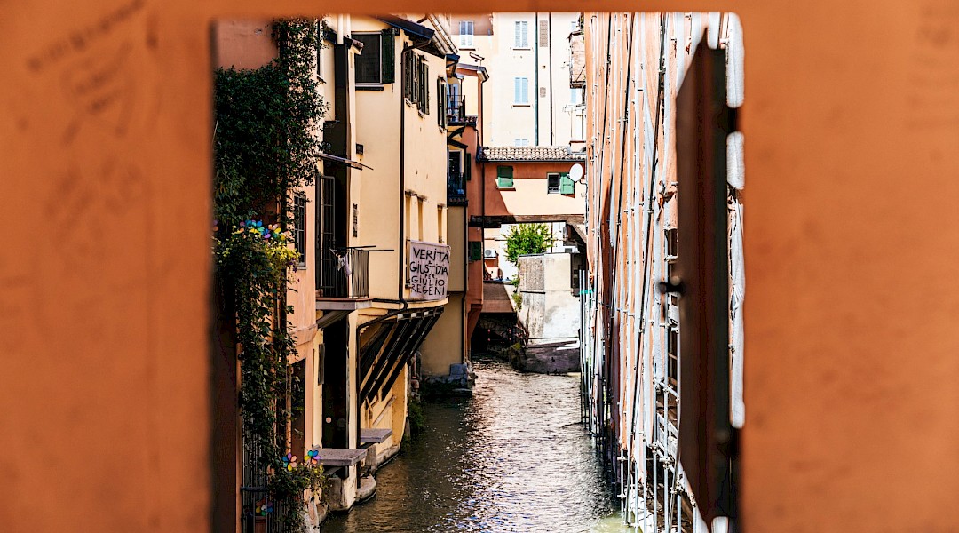 Moline Canal viewed through a small wall window, Bologna. Bianca Ackermann@Unsplash