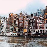 Canal boats, Amsterdam, Holland. Unsplash:Nastya Dulhiier