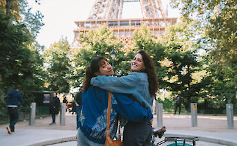 Friends' photo at the Eiffel Tower, Paris bike tour, France. CC:TO