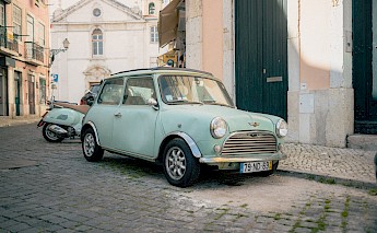 Class Mini Cooper on the streets of Alfama, Lisbon, Portugal. Asa Rodger@Unsplash
