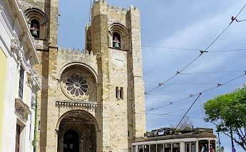 Tram and people outside the Lisbon Cathedral. Mark Lawson@unsplash