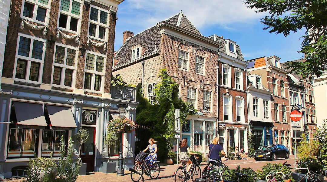 Lady cycling through Utrecht, Utrecht bike tour, Holland. Alain Rouiller@Unsplash