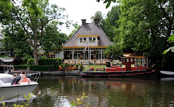 A colorful house by the river, Vecht River, Utrecht, Holland. Henk Monster@Wikimedia Commons