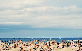 Sunbathers on Barceloneta Beach, Barcelona, Spain. Federico Giampieri@Unsplash