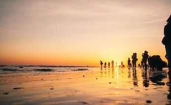 Walking on the beach at sunset, Brighton, Sussex, England. Ben Collins@Unsplash