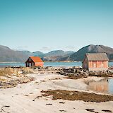 Wooden cottages at a beach in Tromso, Norway. Thomas Claeys@Unsplash