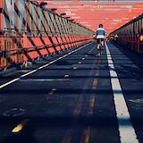 Cyclists passing the Willamsburg Bridge, Willamsburg, New York. Johny Vino@Unsplash