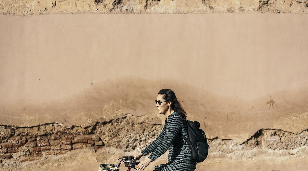 Cycling past ancient walls, Marrakesh, Morocco. CC:Pikala Bikes