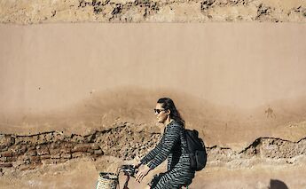 Cycling past ancient walls, Marrakesh, Morocco. CC:Pikala Bikes