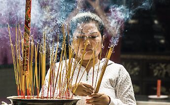 Culture in display, Incense burning by a local in Ho Chi Minh City, Vietnam. Guille Alvarez@Unsplash