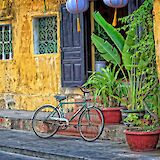 Old yellow house with a bike parked outside, Ho Chi Minh City, Vietnam. Steve douglas@Unsplash
