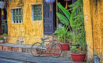 Old yellow house with a bike parked outside, Ho Chi Minh City, Vietnam. Steve douglas@Unsplash