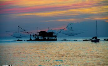 Sunset fishing at Bocca d'Arno, or mouth of the Arno, is the traditional denomination of the late course of the Arno river, Pisa. Roberto de Lisa@Wikimedia Commons