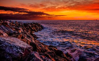 Sunset at the beach near Port of Pisa. LuigiPietroScantamburlo@Wikimedia Commons