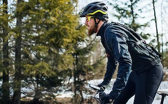 Cycling past snowy woodland. Getty Images@Unsplash