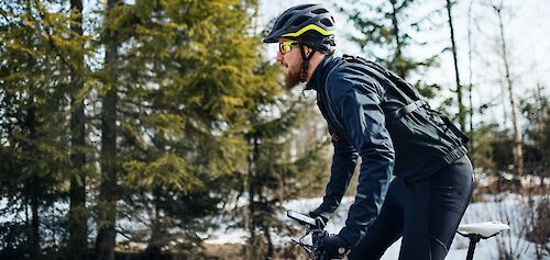 Cycling past snowy woodland. Getty Images@Unsplash