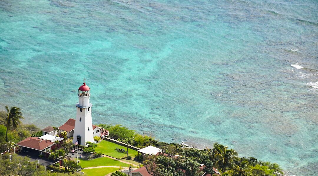Trees, A lighthouse, and the clear ocean waters, Honolulu, Hawaii, USA. Look Up Look Down Photography@Unsplash