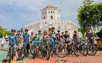 Bike tourists of all ages stopping for a photo in Bangkok, Thailand. Grasshopper Day tours