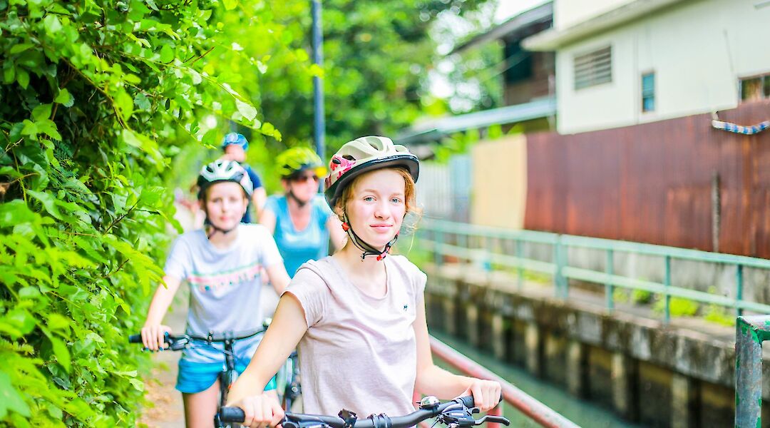 Biking through the side roads of Bangkok, Thailand. Grasshopper Day Tours
