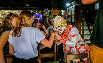 Local in traditional costume greeting tourists in Bangkok, Thailand. Grasshopper Day tours