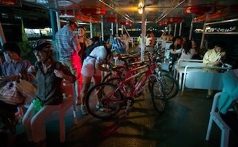 Canal boat ride at night with bikes, Bangkok, Thailand. CC:Grasshopper Day Tours