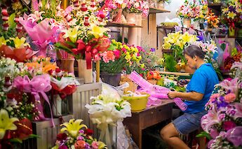Flower stand busy at night in Bangkok, Thailand. CC:Grasshopper Day Tours