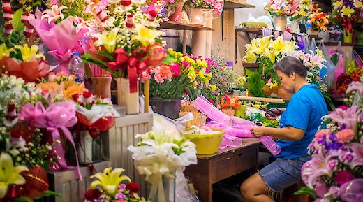 Flower stand busy at night in Bangkok, Thailand. CC:Grasshopper Day Tours