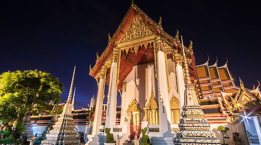 White and gold temple at night, Bangkok, Thailand. CC:Grasshopper Day Tours